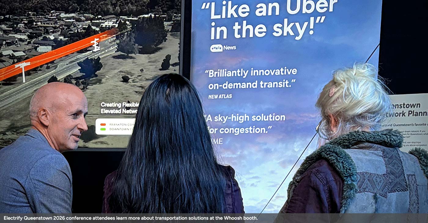 Electrify Queenstown 2026 conference attendees learn more about transportation solutions at the Whoosh booth.